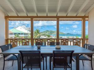 a table and chairs on a porch with a view of the ocean at Appartement Saint-Martin , 4 pièces, 8 personnes - FR-1-734-2 in Saint Martin