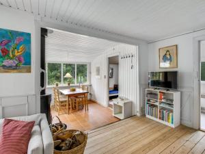 a living room with a couch and a table at Holiday Home Gaelle - 800m from the sea in Western Jutland by Interhome in Vejers Strand