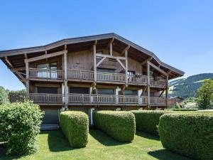 a large wooden house with bushes in front of it at Studio Megève, 1 pièce, 4 personnes - FR-1-453-73 in Megève