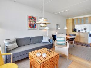 a living room with a couch and a table at Apartment Eske - 50m from the sea in Western Jutland by Interhome in Fanø