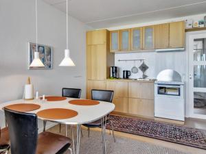 a kitchen and dining room with a table and chairs at Apartment Eske - 50m from the sea in Western Jutland by Interhome in Fanø