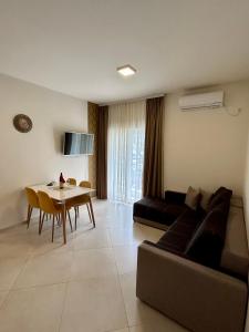 a living room with a couch and a table at APARTMENTS TOMIĆ in Becici