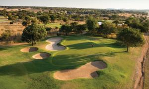 an overhead view of a golf course with a golfer on the green at Zebula Golf Estate and Spa - Zebula Golfers Lodge in Mabula