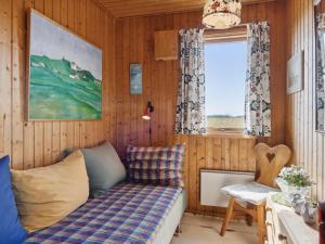 um quarto com um sofá e uma janela em Holiday Home Lok - 450m from the sea in NW Jutland by Interhome em Lokken