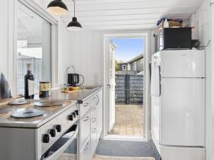 eine Küche mit einem weißen Kühlschrank und einer offenen Tür in der Unterkunft Holiday Home Kielo - all inclusive - 200m to the inlet by Interhome in Løgstør