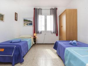 a room with two beds and a window at Apartment Riells Platja by Interhome in L'Escala