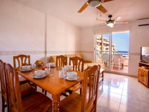 a dining room with a wooden table and chairs at Apartment Dianium-1 by Interhome in Denia