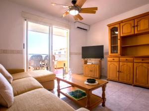 a living room with a couch and a flat screen tv at Apartment Dianium-1 by Interhome in Denia