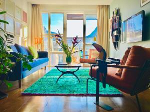 a living room with a couch and a table at Ipanema Duplex Penthouse in Rio de Janeiro