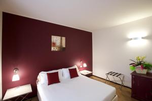Postel nebo postele na pokoji v ubytování Hotel Leon D'Oro