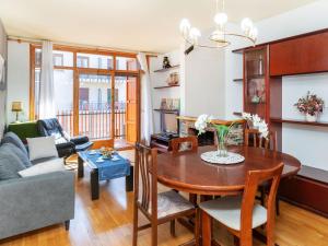 a living room with a table and a couch at Apartment Mainera by Interhome in Sort