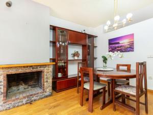 Apartment Mainera by Interhome في سورت: غرفة طعام بها موقد وطاولة وكراسي