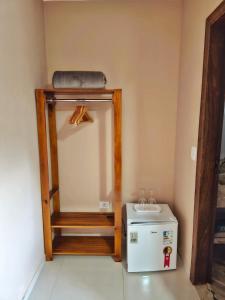 a room with a mirror and a small refrigerator at Pássaros do Cerrado Suítes in Alto Paraíso de Goiás +89 photos