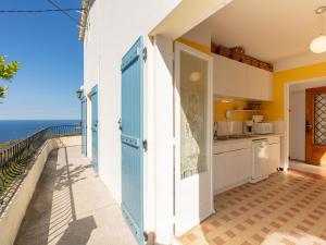 a kitchen with a view of the ocean at Apartment Chantelyre-1 by Interhome in Carqueiranne