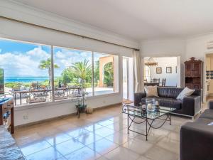 a living room with a couch and a view of the ocean at Holiday Home Las Gaviotas Style & Charm by Interhome in Colonia Sant Jordi