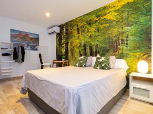 a bedroom with a bed with a painting on the wall at Villa Villa Luxury Rock Tirri by Interhome in Reus