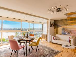 a living room with a table and chairs and a couch at Holiday Home Belvédère sur la Mer by Interhome in Locquirec