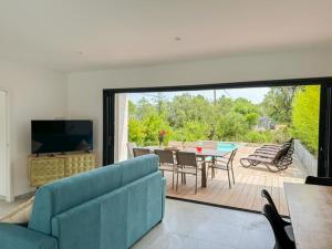 a living room with a blue couch and a table at Apartment Villa Kalliste by Interhome in Favone