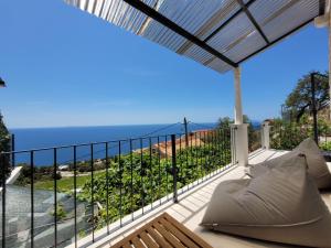 a balcony with a view of the ocean at Holiday Home Cicak by Interhome in Sveta Nedelja