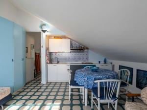 - une cuisine et une salle à manger avec une table et des chaises dans l'établissement Apartment Attic Beach by Interhome, à Laigueglia