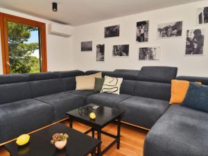 a living room with a couch and a table at Holiday Home Villa Baraka by Interhome in Božava