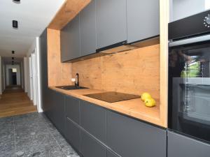 a kitchen with gray cabinets and a counter with yellow fruit at Holiday Home Villa Baraka by Interhome in Božava