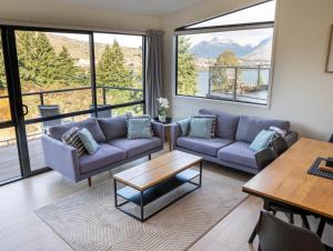 a living room with a couch and a table at Wild Remarks in Queenstown