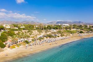 an aerial view of a beach with umbrellas at Villa Archimedes in Peyia