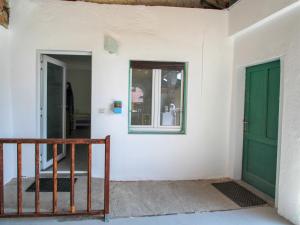 a room with a green door and a window at Studio Borghetto-2 by Interhome in Agra