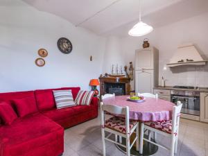 a living room with a red couch and a table at Holiday Home Casa Violella by Interhome in Chiusi