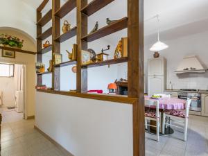 a kitchen with wooden shelves and a table at Holiday Home Casa Violella by Interhome in Chiusi
