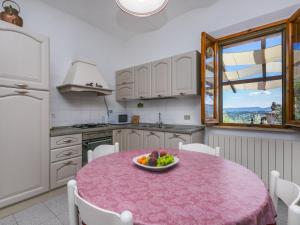 a kitchen with a table with a bowl of fruit on it at Holiday Home Casa Violella by Interhome in Chiusi +26 photos