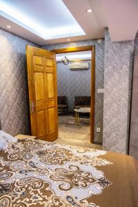 a bedroom with a bed and a wooden door at ROYAL SUİT in Bursa