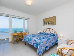 a bedroom with a bed and a view of the ocean at Apartment Massimo Beach House by Interhome in Rosignano Solvay