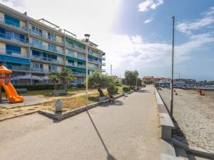a building on the beach with a playground at Apartment Massimo Beach House by Interhome in Rosignano Solvay