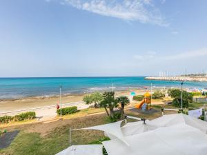 a view of a beach with a playground and the ocean at Apartment Massimo Beach House by Interhome in Rosignano Solvay