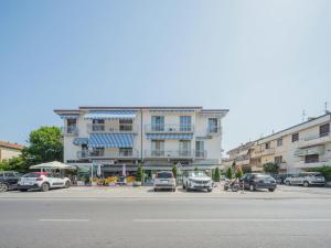 a building with cars parked in a parking lot at Apartment Cinzia by Interhome in Viareggio