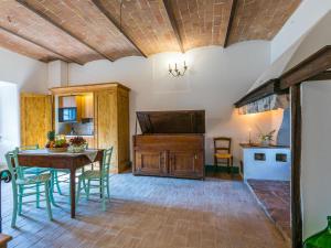 a kitchen and dining room with a wooden table and chairs at Apartment Torre 2 by Interhome in Stigliano