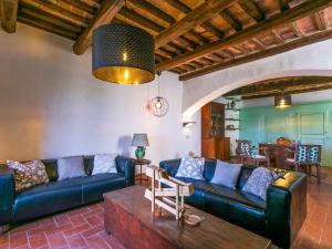 ein Wohnzimmer mit blauen Sofas und einem Tisch in der Unterkunft Holiday Home La Torre by Interhome in Stigliano