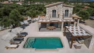 an aerial view of a villa with a swimming pool at Bedrock beachside villa with private pool in Vasilikos +24 photos