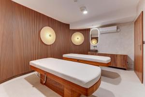 a bedroom with two beds and a wooden wall at Grano Solmarina - Marina Residence SPA&Wellness in Wiślinka
