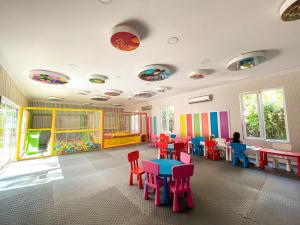 a room with colorful tables and chairs in a kindergarten at Catamaran Quality Times in Beldibi