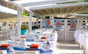 una fila di tavoli bianchi con lastre rosse e blu di Catamaran Quality Times a Beldibi