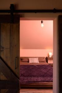 a bedroom with a bed and a pink wall at Beautiful Villa Pool and magic sunsets Croatia in Kuzminec