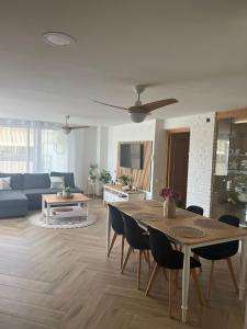 a living room with a table and a blue couch at Beachfront Salou apartment with sea view in Salou