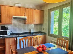a kitchen with a table with a bowl of fruit on it at Vista Arinsal Apartments in Arinsal