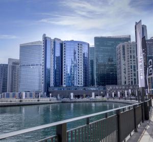 a river in a city with tall buildings at Radisson Blu Hotel, Dubai Waterfront in Dubai