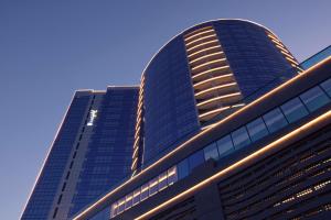 Radisson Blu Hotel, Dubai Waterfront في دبي: مبنى طويل مع سماء زرقاء في الخلفية