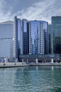 a view of a city with tall buildings and the water at Radisson Blu Hotel, Dubai Waterfront in Dubai