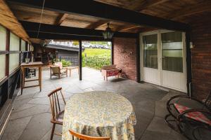 a patio with a table and chairs on a patio at Tiglkåk in Åndalsnes